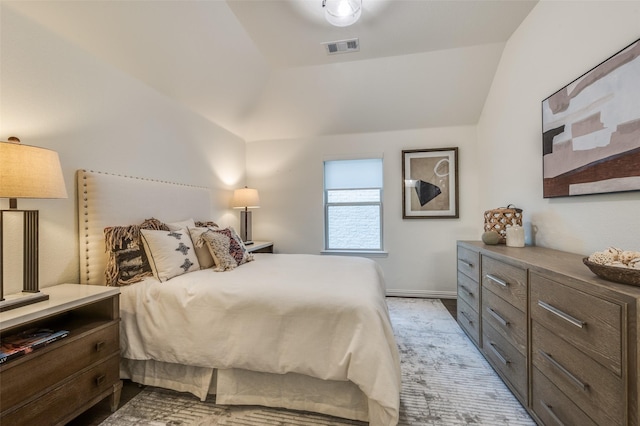 bedroom with visible vents, baseboards, and vaulted ceiling