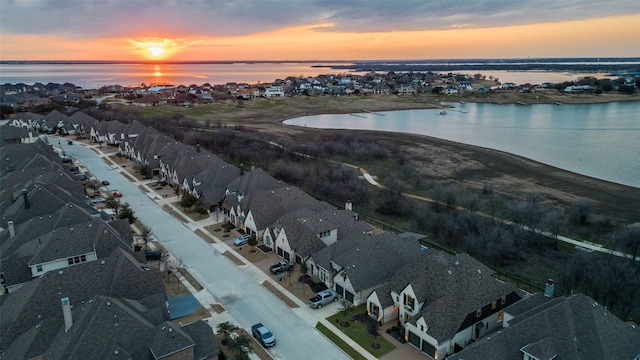 drone / aerial view with a residential view and a water view