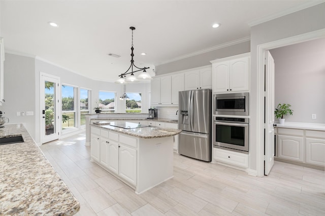 kitchen with stainless steel appliances, backsplash, visible vents, and white cabinets