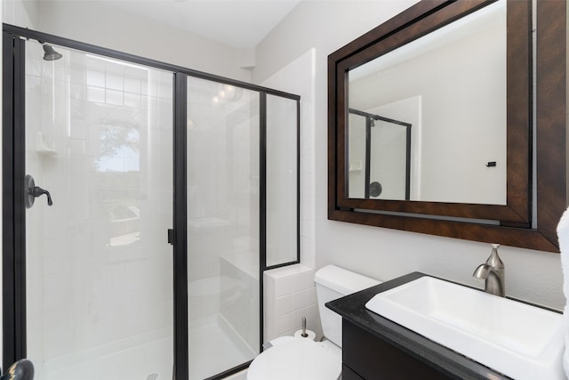 full bathroom with a stall shower, vanity, and toilet