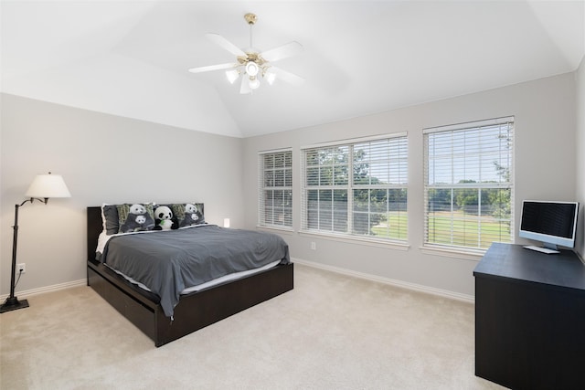 bedroom with lofted ceiling, light carpet, and baseboards