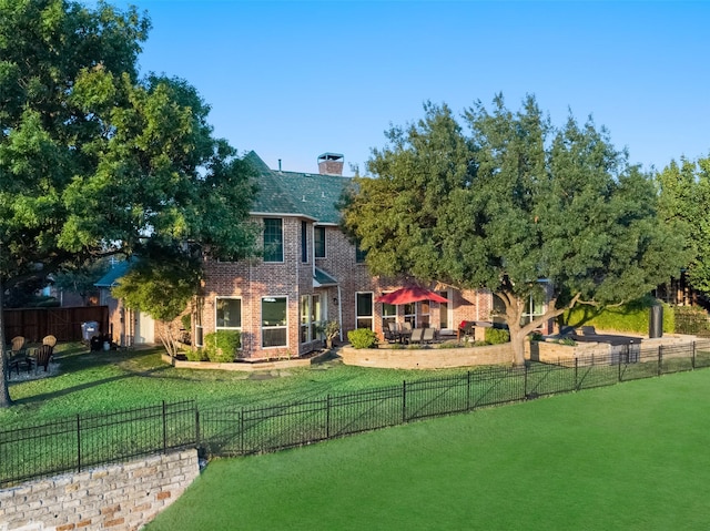 exterior space featuring a lawn, a patio area, and a fenced backyard