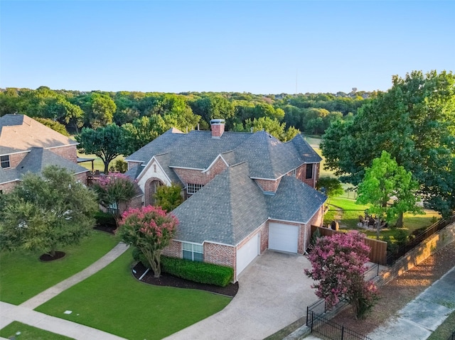 aerial view featuring a wooded view