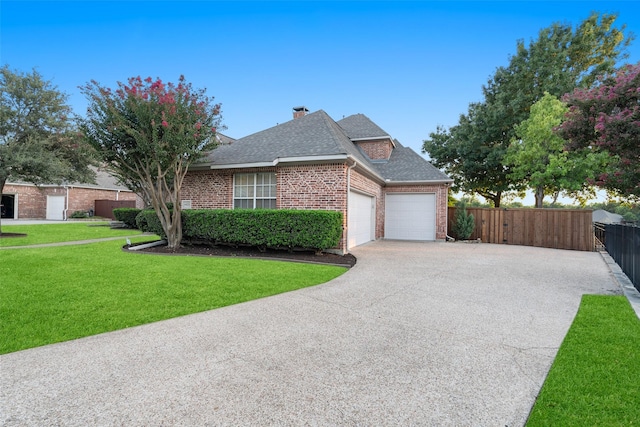 view of front of house featuring brick siding, roof with shingles, fence, driveway, and a front lawn