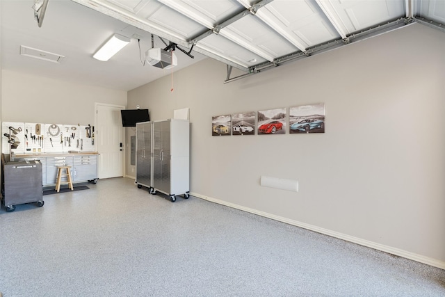 garage with baseboards and a garage door opener