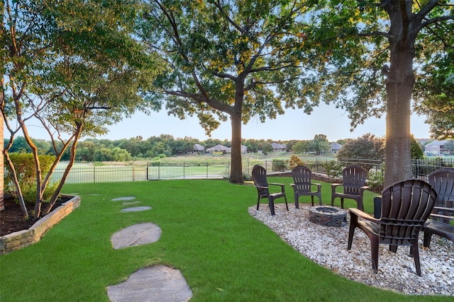 view of yard with an outdoor fire pit and a fenced backyard