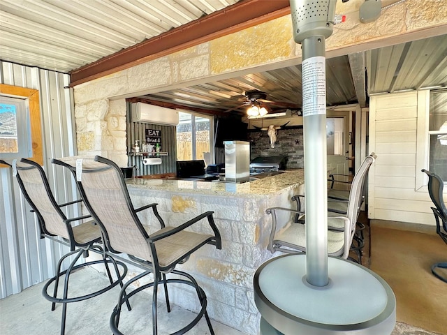 view of patio with a wall unit AC and outdoor wet bar