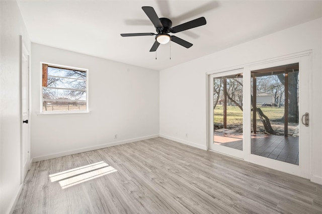 unfurnished room with ceiling fan, baseboards, and wood finished floors