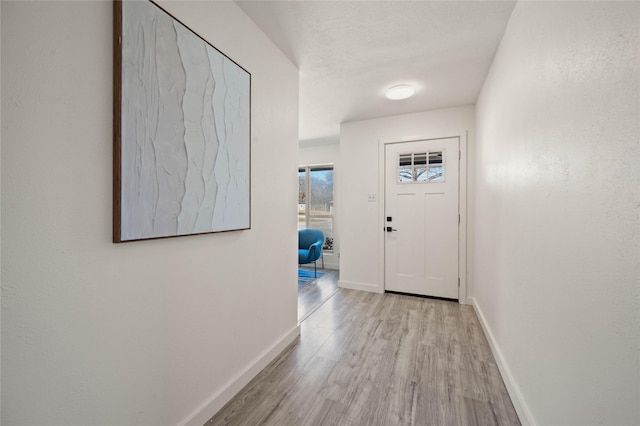 interior space featuring wood finished floors and baseboards