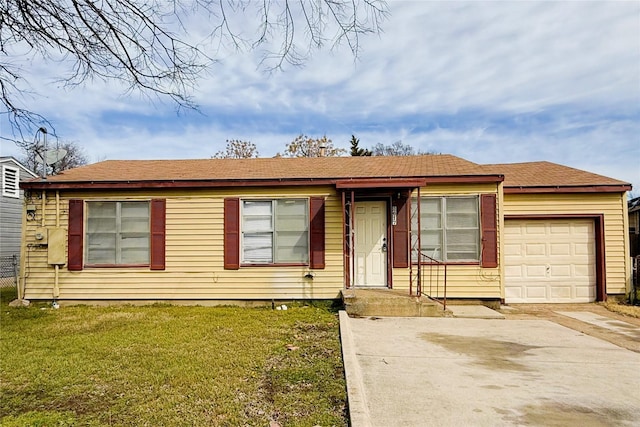 view of front facade with a front yard, concrete driveway, and an attached garage