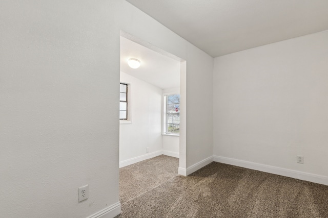 empty room with carpet flooring and baseboards