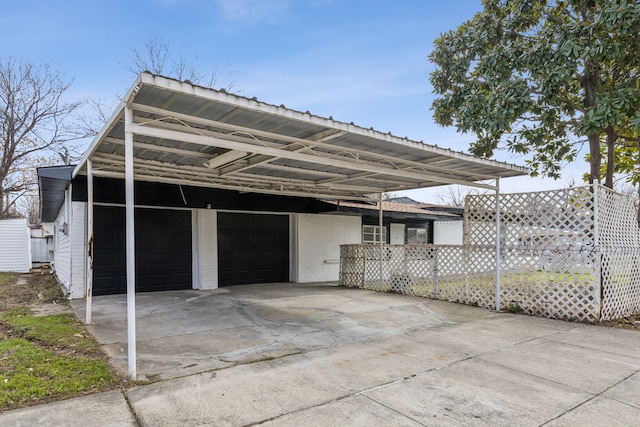 view of vehicle parking with an attached garage and a carport