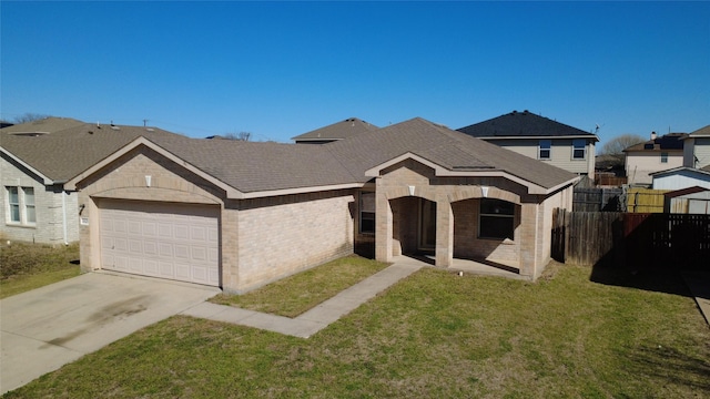 view of front of house with a garage, concrete driveway, fence, a front lawn, and brick siding