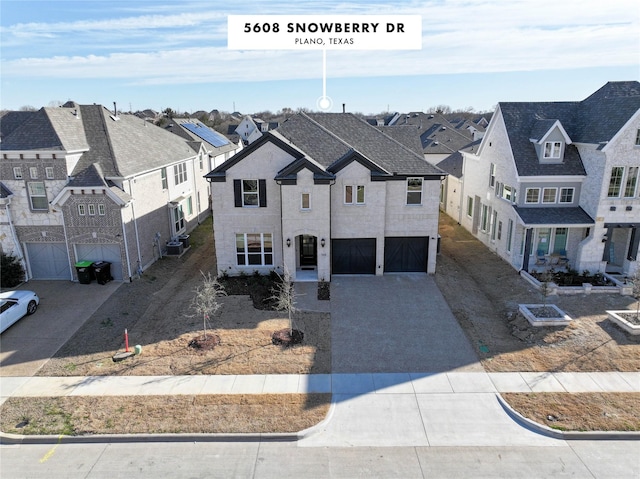 view of front of house featuring a residential view, driveway, and an attached garage