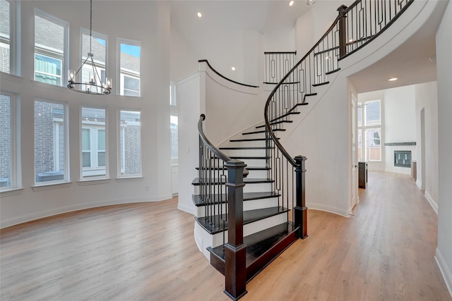 entrance foyer featuring wood finished floors, a wealth of natural light, and baseboards