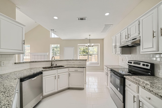 kitchen with visible vents, appliances with stainless steel finishes, a sink, a peninsula, and under cabinet range hood