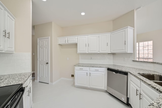 kitchen featuring white cabinets, stainless steel dishwasher, and light stone countertops