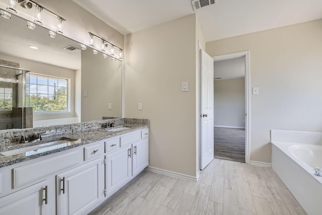 full bath with a stall shower, visible vents, and a sink