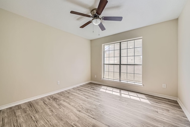 spare room with light wood-style flooring, baseboards, and ceiling fan