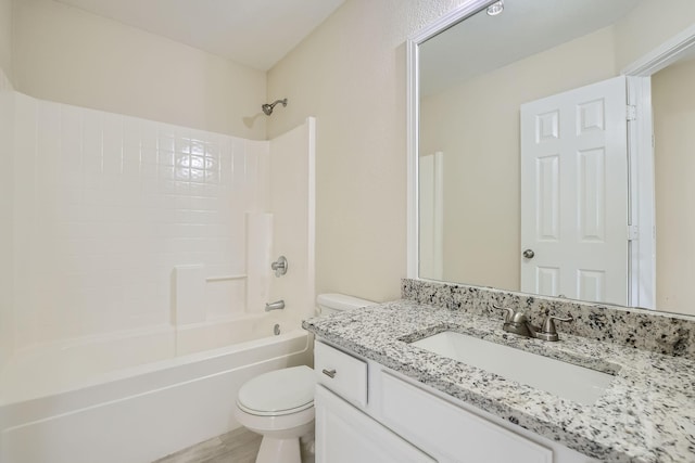 bathroom with wood finished floors, vanity, toilet, and bathing tub / shower combination