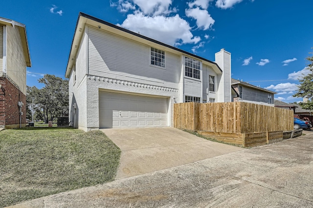 view of front of property with a garage, driveway, a front yard, and fence