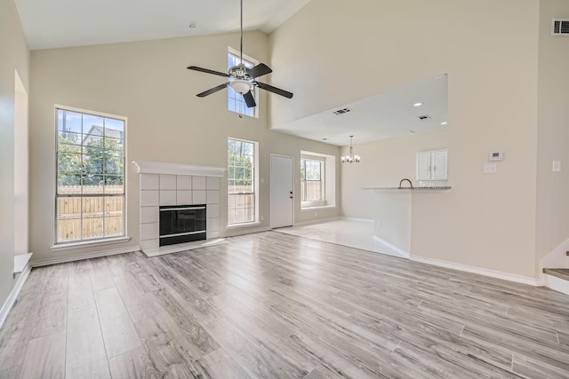 unfurnished living room with light wood-style floors, visible vents, and a fireplace