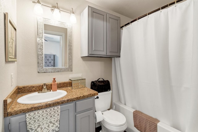 bathroom featuring shower / bath combo, vanity, and toilet