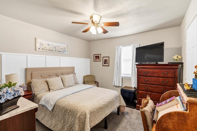 bedroom featuring a ceiling fan and a textured ceiling