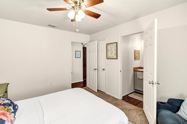 bedroom featuring ceiling fan, visible vents, and baseboards