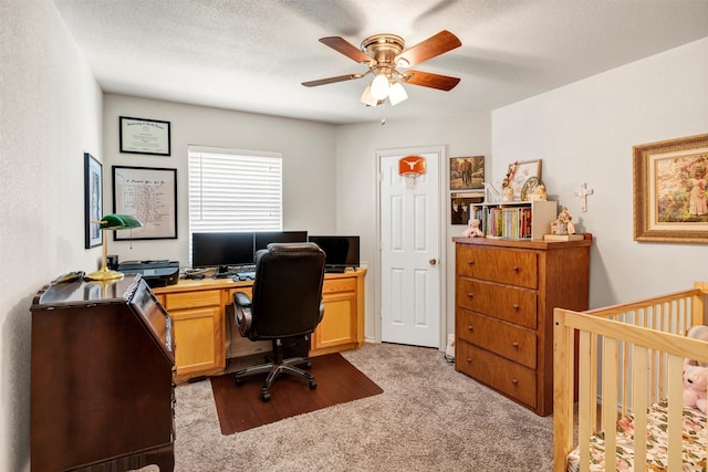 office with light carpet, a ceiling fan, and a textured ceiling