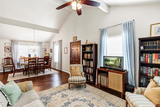 living area featuring ceiling fan with notable chandelier, high vaulted ceiling, wood finished floors, and baseboards