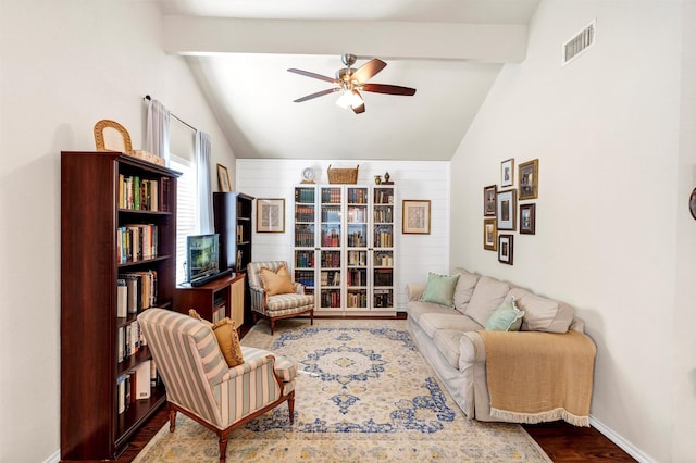 living room with vaulted ceiling with beams, visible vents, ceiling fan, wood finished floors, and baseboards