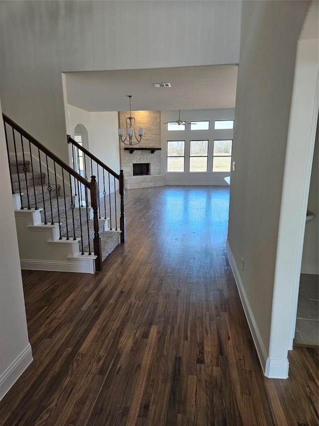 interior space with visible vents, baseboards, and dark wood finished floors