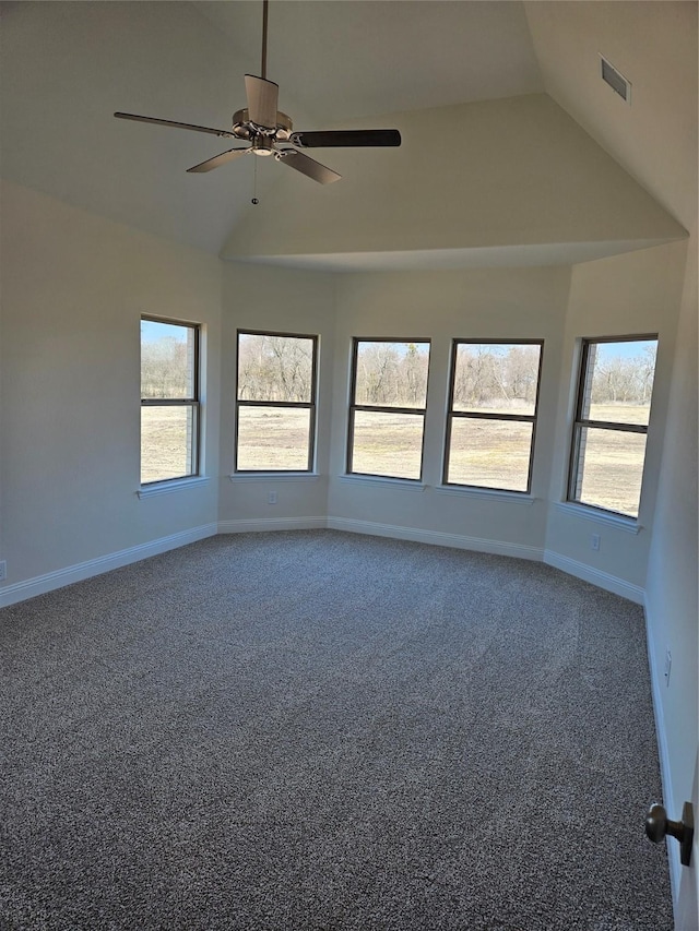 carpeted empty room featuring a ceiling fan, plenty of natural light, visible vents, and baseboards