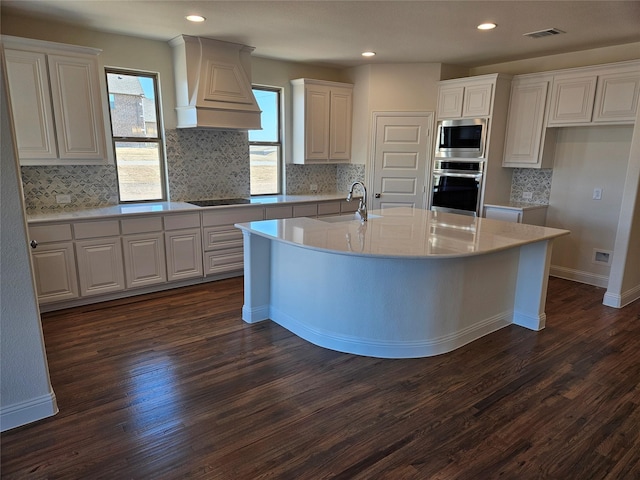 kitchen with stainless steel appliances, visible vents, white cabinetry, light countertops, and custom exhaust hood