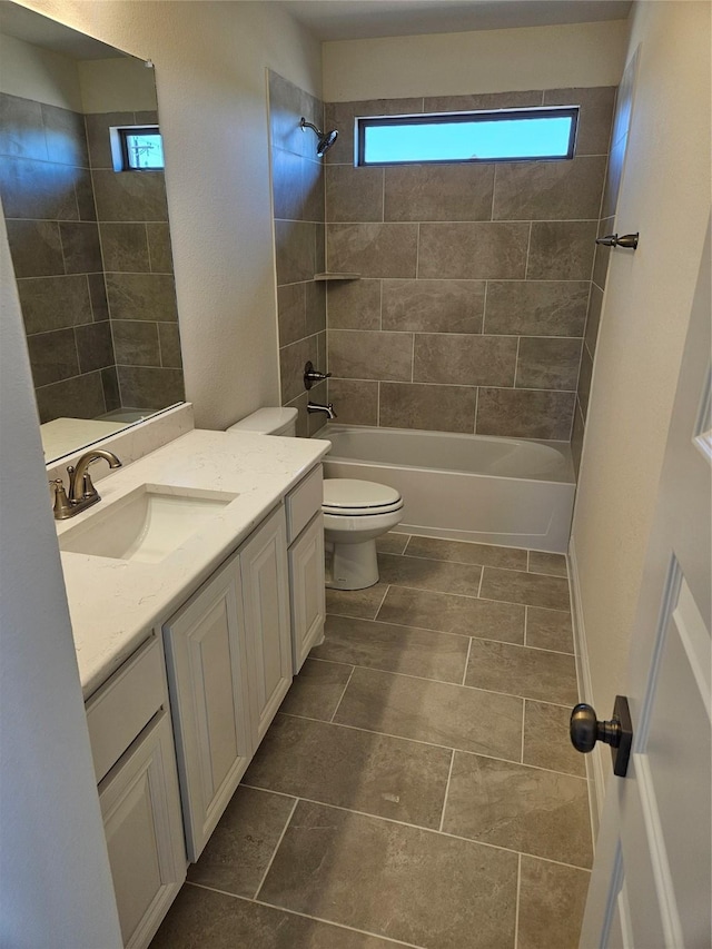 full bath with washtub / shower combination, plenty of natural light, vanity, and toilet