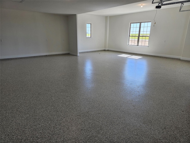 empty room with speckled floor and baseboards