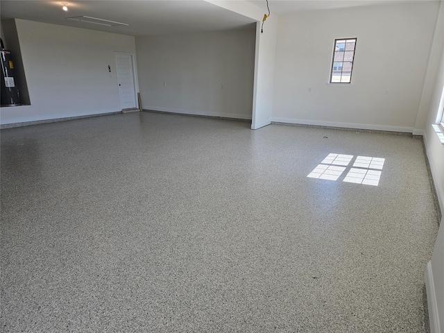 interior space featuring baseboards and electric water heater