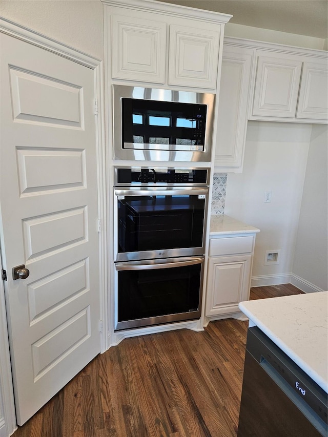 kitchen with appliances with stainless steel finishes and white cabinetry