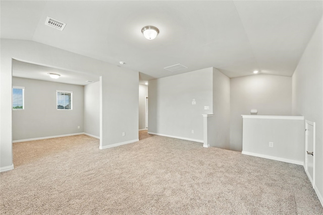 basement featuring carpet floors, baseboards, and visible vents