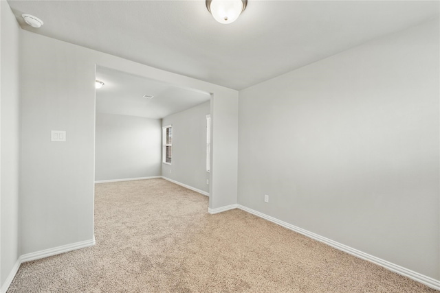 carpeted spare room with baseboards