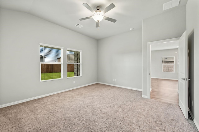 unfurnished room featuring carpet, visible vents, ceiling fan, and baseboards