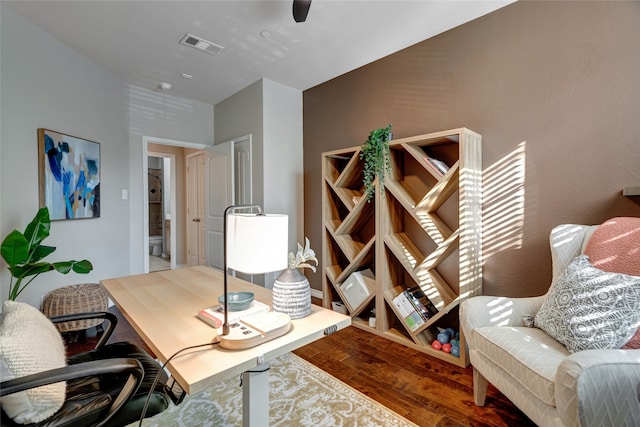 office space featuring wood finished floors and visible vents