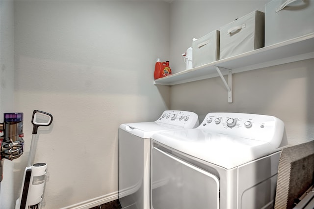 laundry room with laundry area, baseboards, and washer and dryer