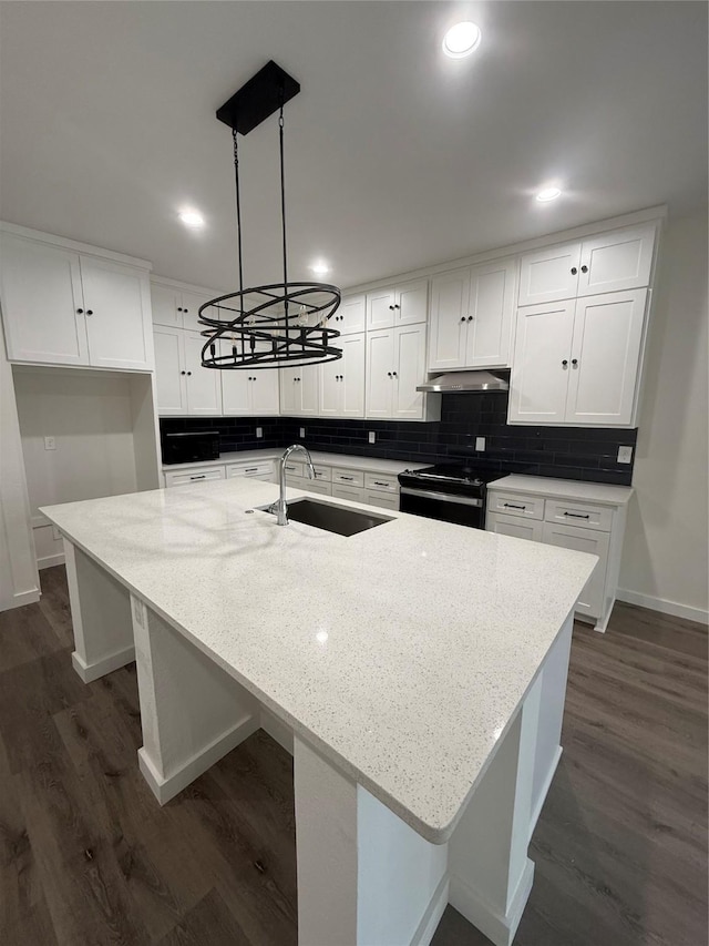 kitchen featuring black electric range, decorative backsplash, white cabinets, a sink, and under cabinet range hood