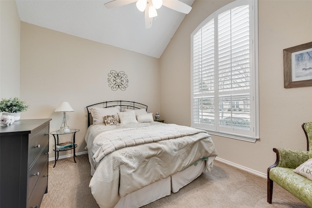 bedroom featuring a ceiling fan, light colored carpet, vaulted ceiling, and baseboards