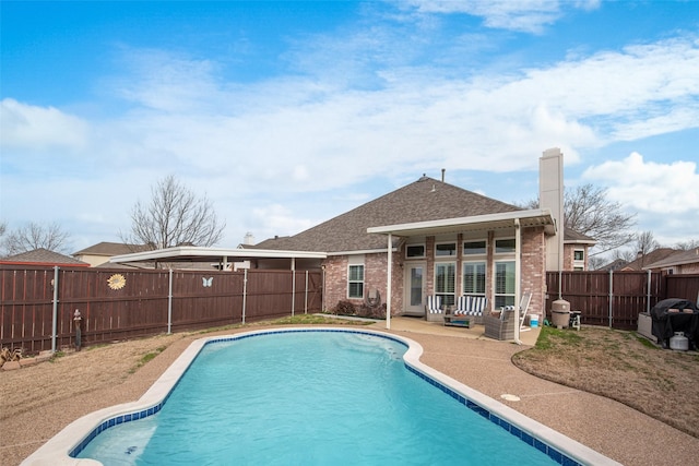 view of pool featuring a patio area, a fenced backyard, and a fenced in pool