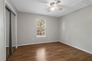 unfurnished bedroom with ceiling fan, a closet, and wood finished floors