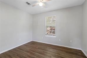 spare room with a ceiling fan, baseboards, visible vents, and wood finished floors