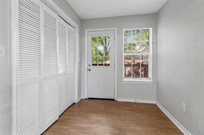 doorway to outside with a healthy amount of sunlight, baseboards, and wood finished floors